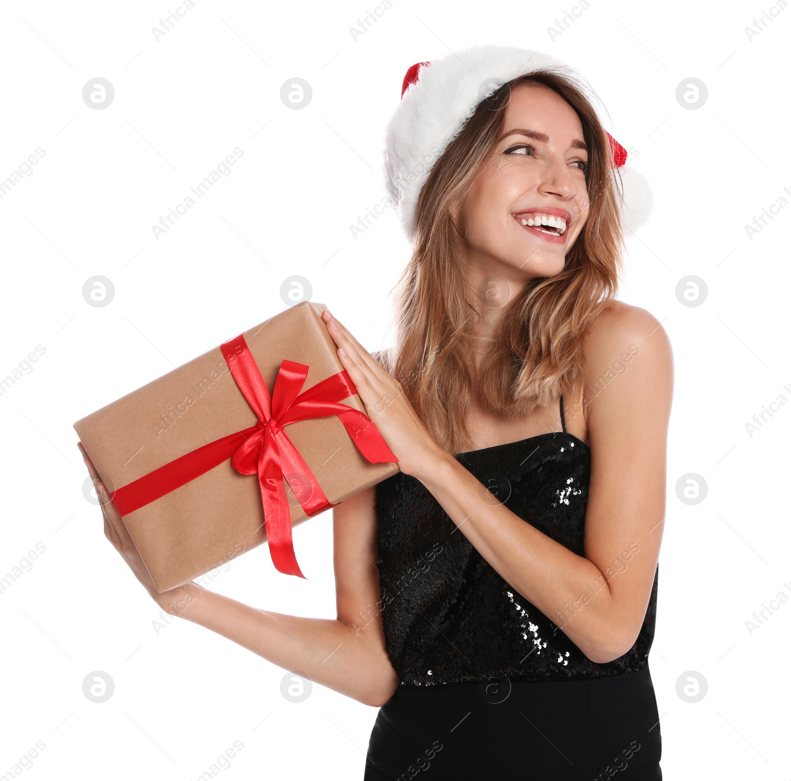 Photo of Happy young woman in Santa hat with gift box on white background. Christmas celebration