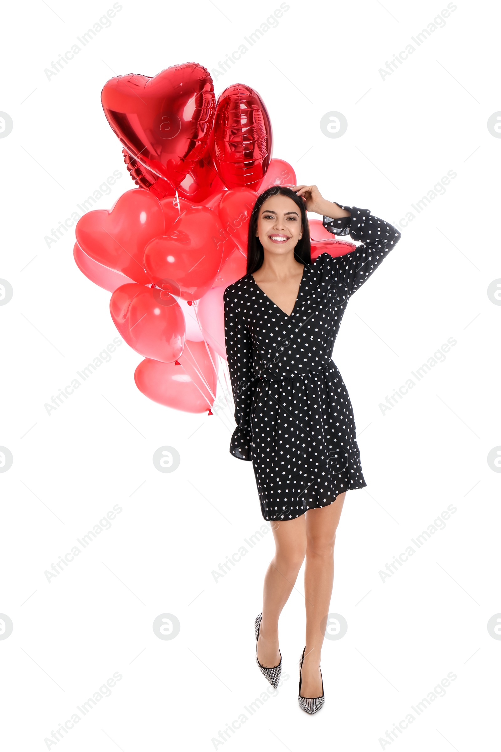 Photo of Beautiful young woman with heart shaped balloons isolated on white. Valentine's day celebration