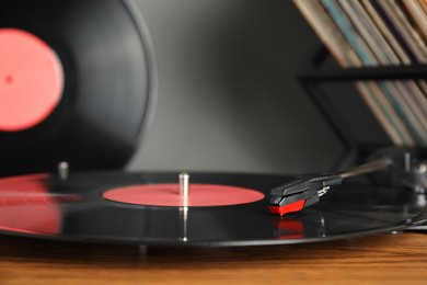 Photo of Modern vinyl record player with disc, closeup