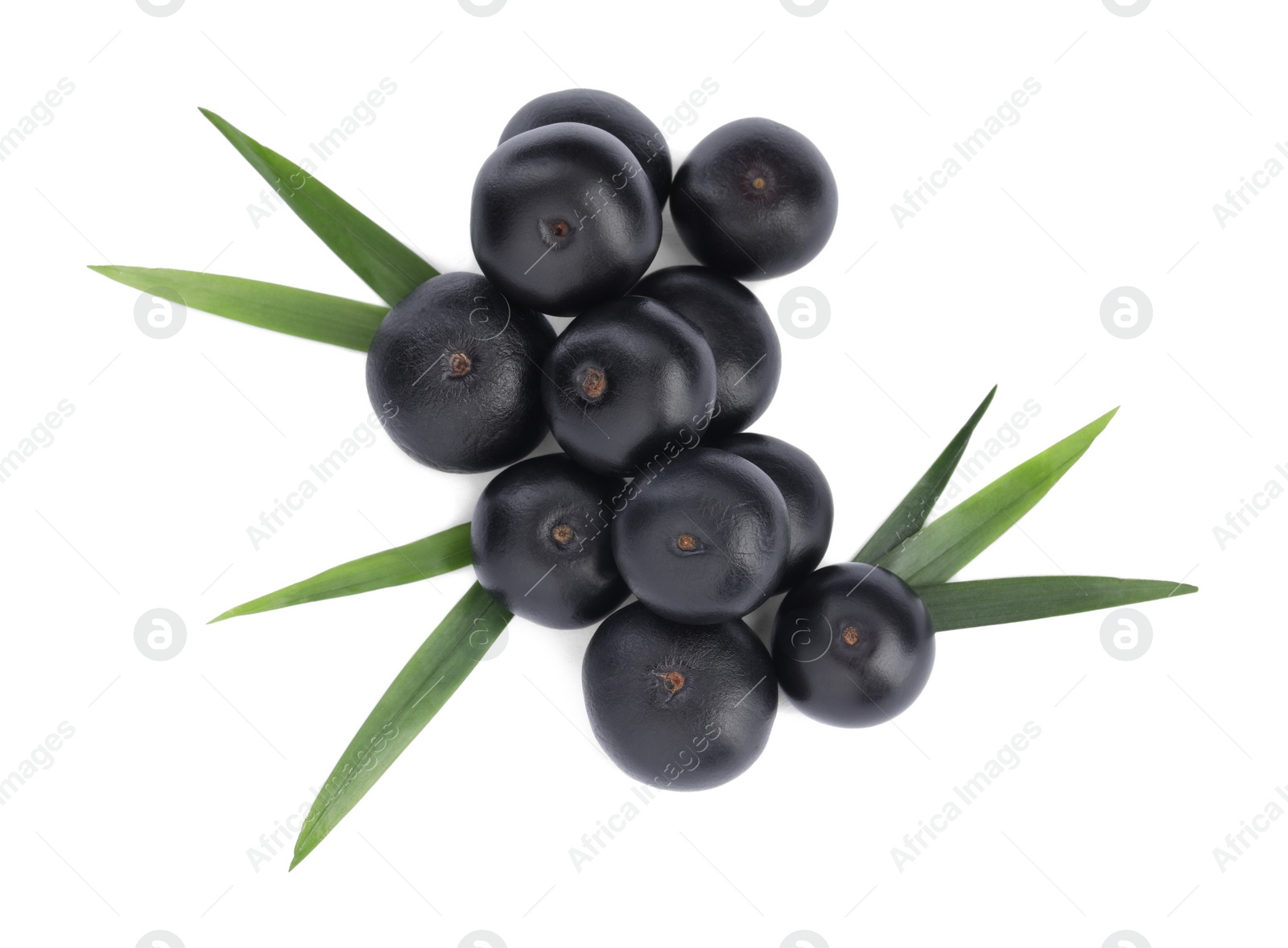 Photo of Pile of fresh ripe acai berries and green leaves on white background, top view