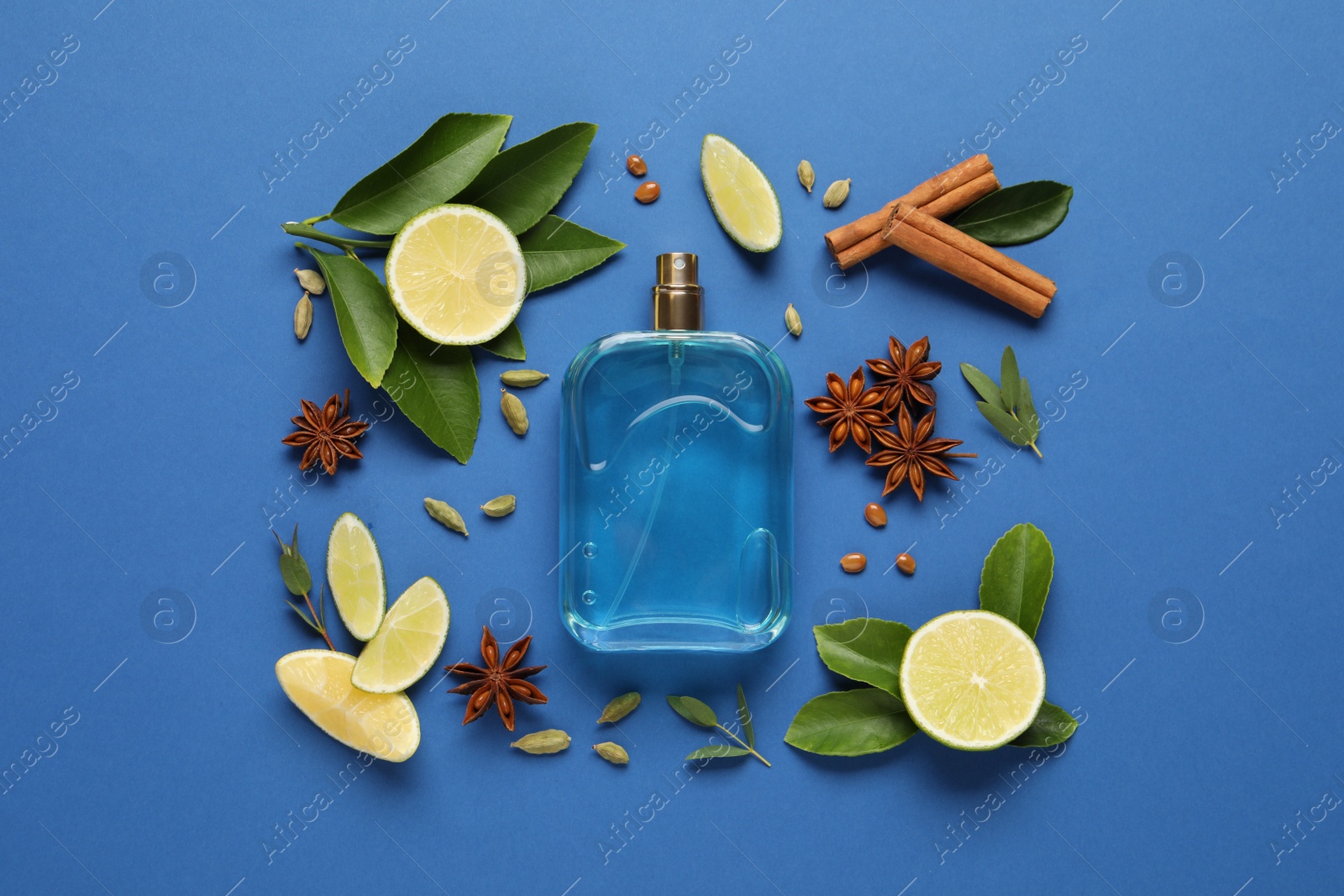 Photo of Flat lay composition with bottle of perfume and fresh citrus fruits on blue background