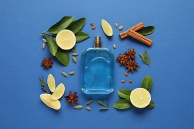 Flat lay composition with bottle of perfume and fresh citrus fruits on blue background