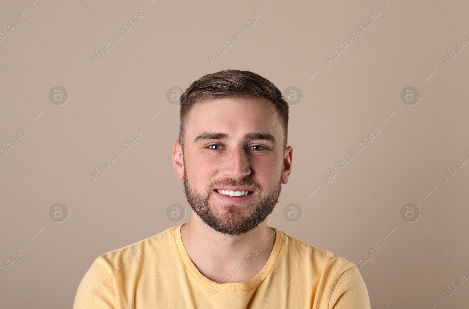 Photo of Young man with healthy teeth on color background