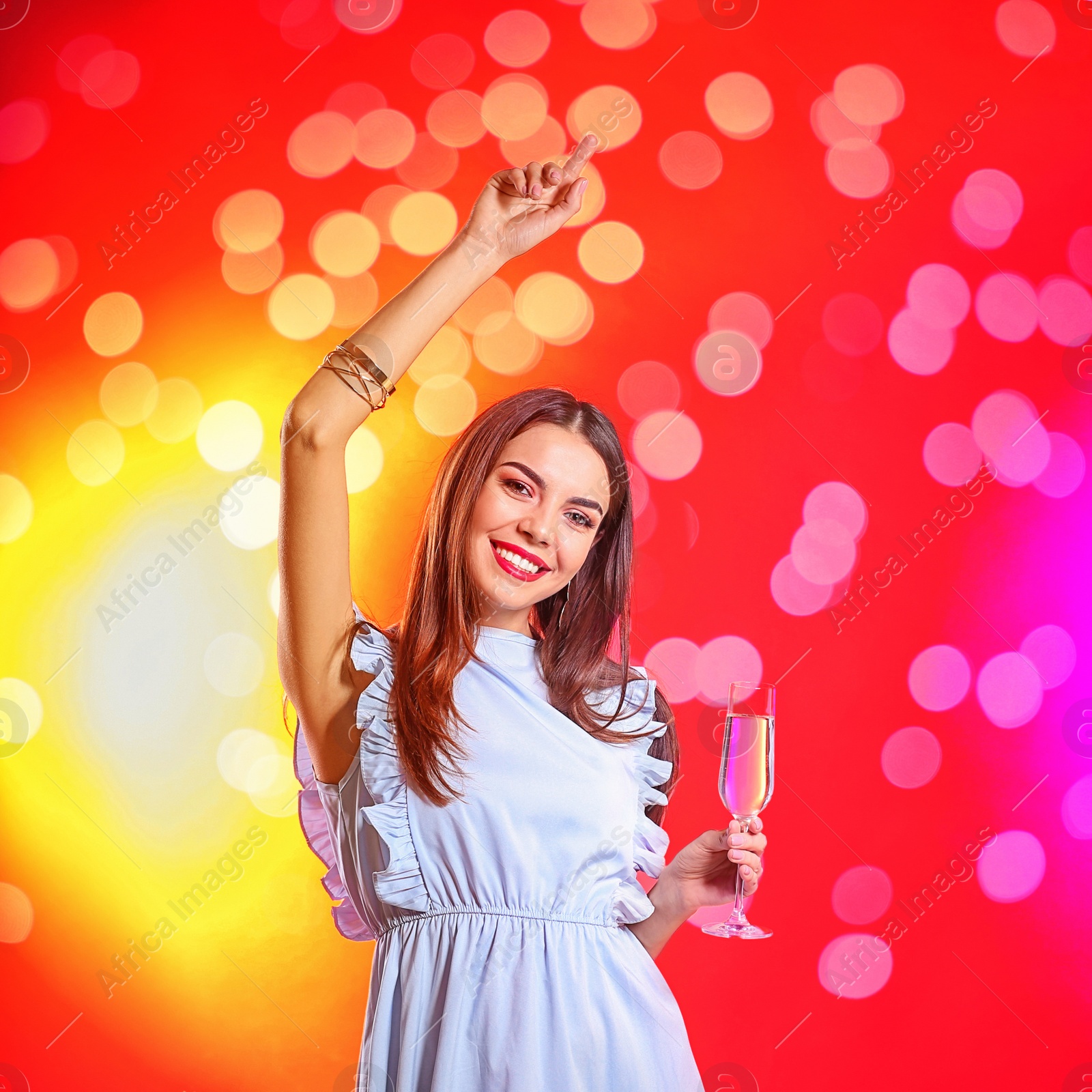 Photo of Portrait of happy woman with champagne in glass on color background