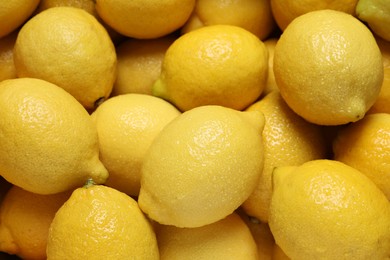 Fresh lemons with water drops as background, closeup