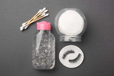 Photo of Flat lay composition with makeup removal tools and false eyelashes on dark grey background
