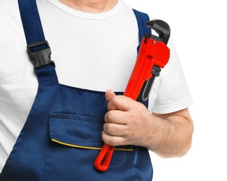 Photo of Mature plumber with pipe wrench on white background