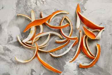 Photo of Dry orange peels on light grey table, flat lay