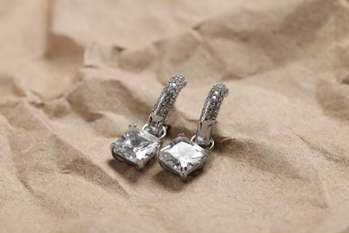 Beautiful earrings on kraft paper. Luxury jewelry