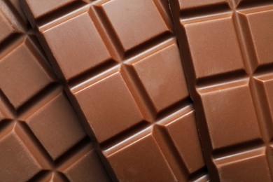 Delicious milk chocolate bars as background, top view