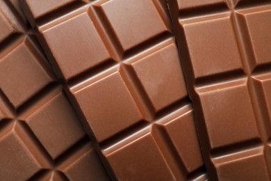 Photo of Delicious milk chocolate bars as background, top view