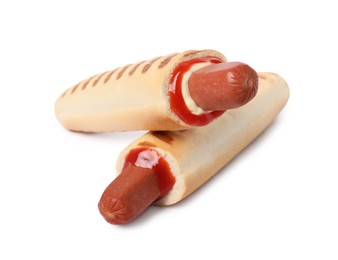 Photo of Tasty french hot dogs with sauce on white background