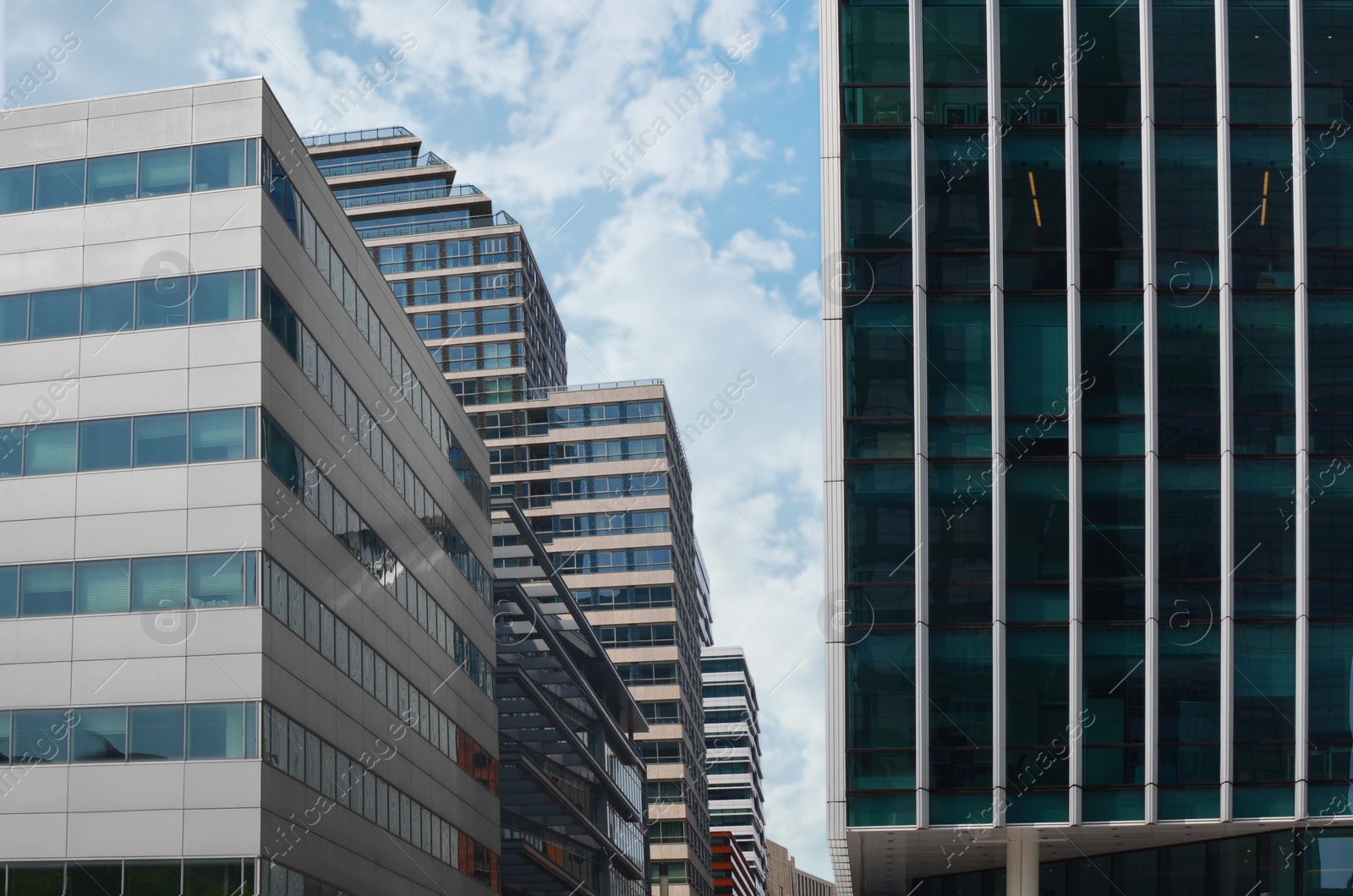 Photo of Exterior of beautiful modern skyscrapers against blue sky