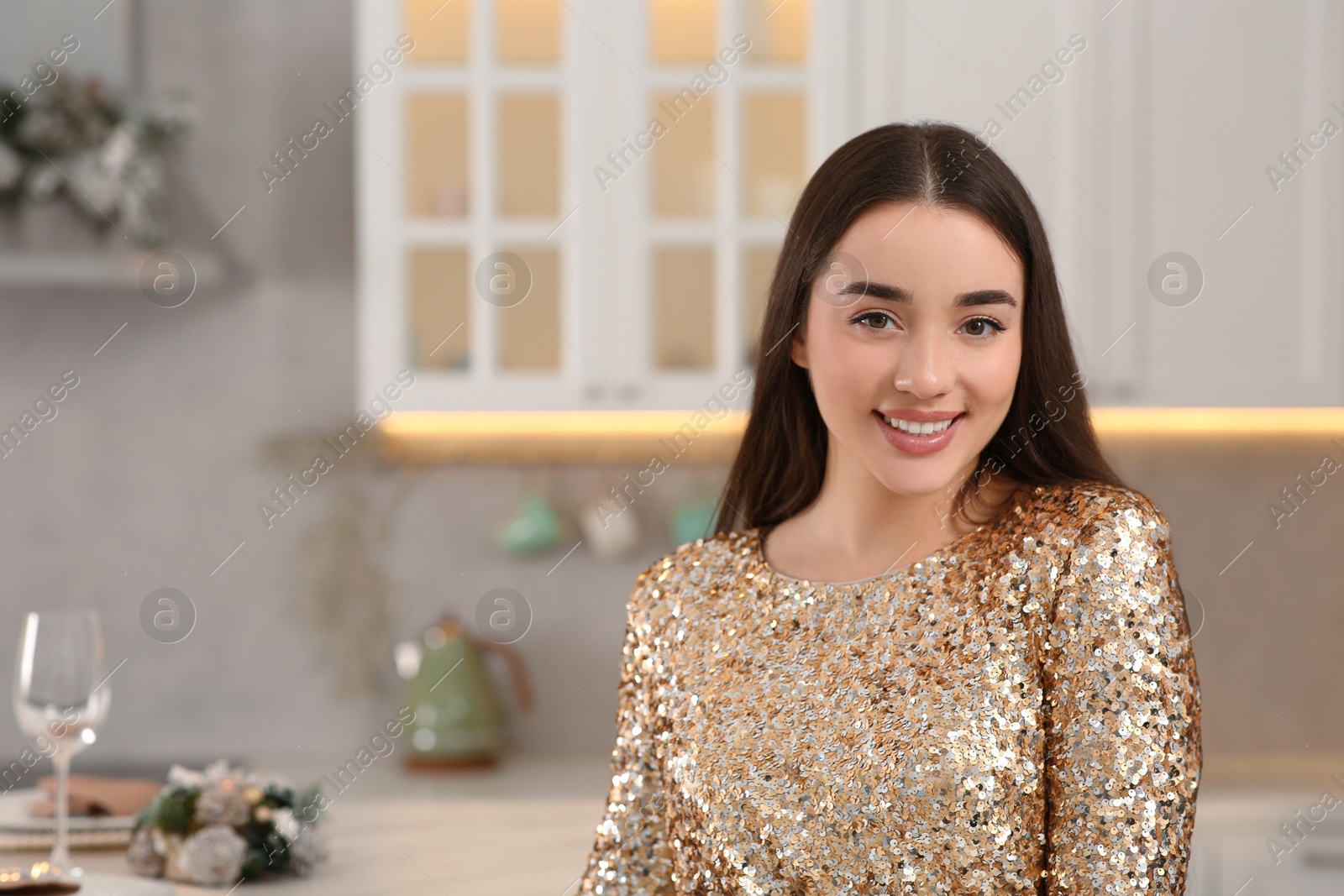 Photo of Christmas mood. Portrait of happy woman wearing festive dress in kitchen. Space for text