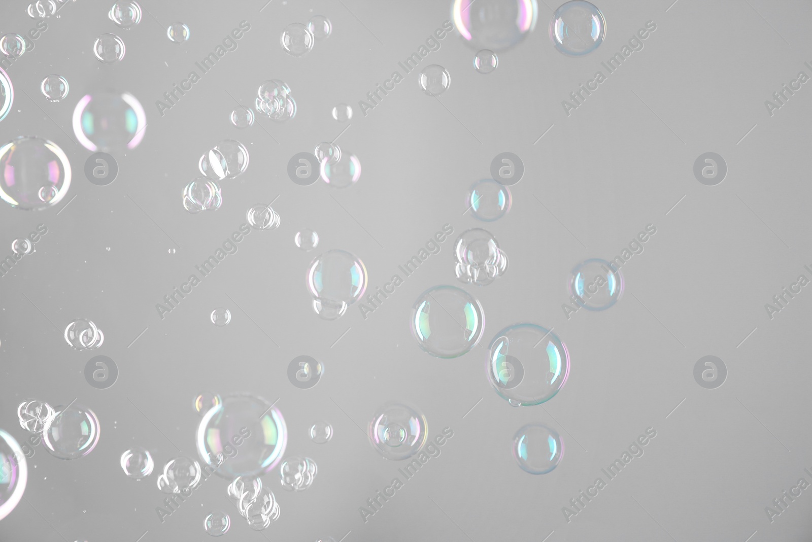 Photo of Beautiful transparent soap bubbles on grey background