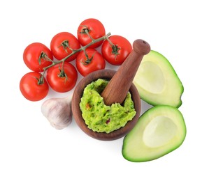 Photo of Mortar with delicious guacamole and ingredients isolated on white, top view