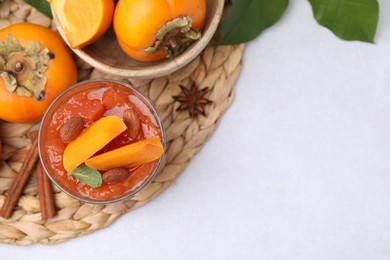 Delicious dessert with persimmon on table, flat lay. Space for text