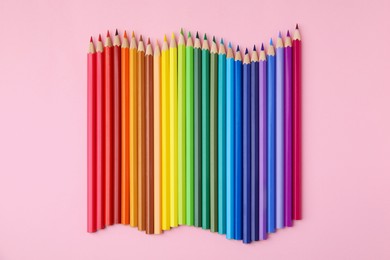 Photo of Colorful wooden pencils on pink background, flat lay