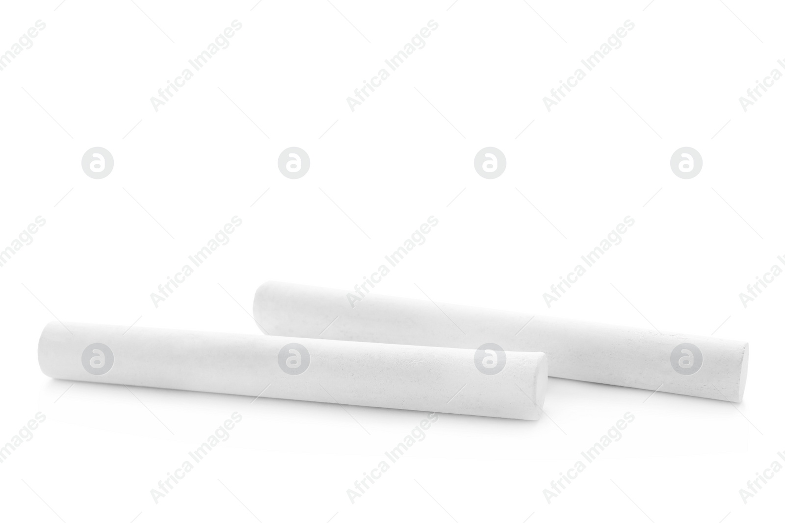 Photo of Small pieces of chalk on white background