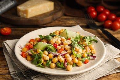 Photo of Delicious fresh chickpea salad on wooden table