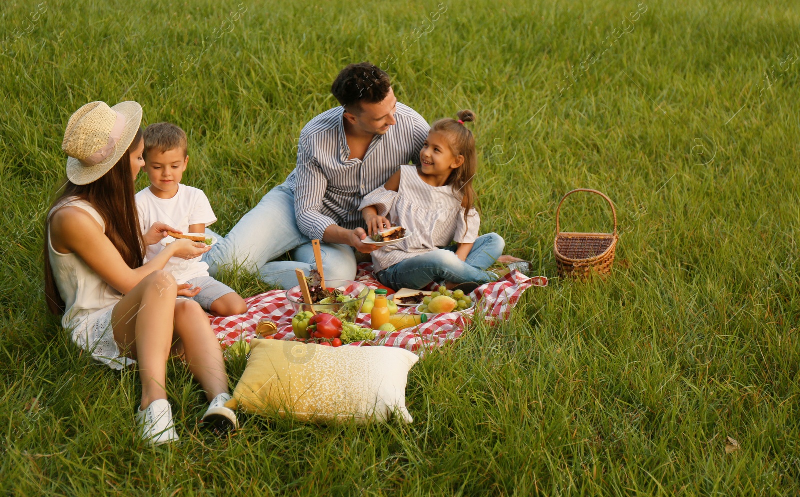 Photo of Happy family having picnic in park on summer day