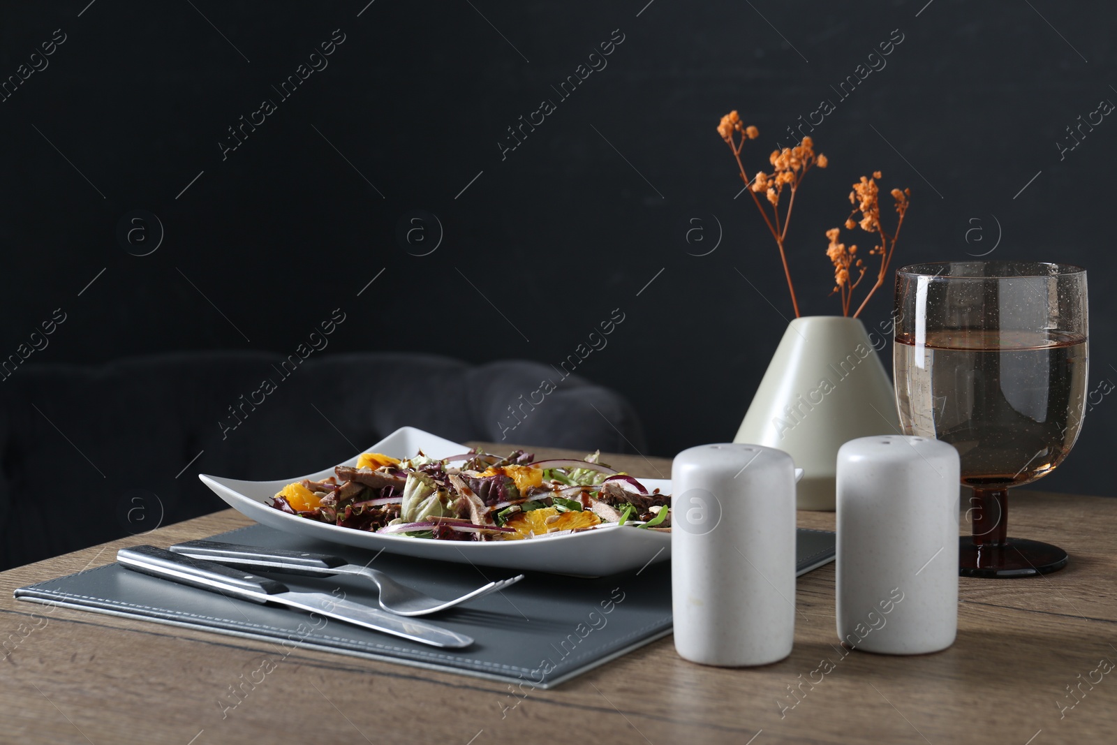 Photo of Delicious salad with beef tongue, orange and onion served on wooden table