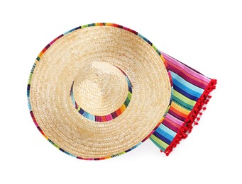 Photo of Mexican sombrero hat and colorful poncho isolated on white, top view