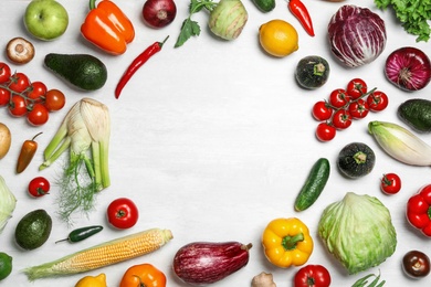 Photo of Frame made of fresh vegetables on light table, flat lay. Space for text