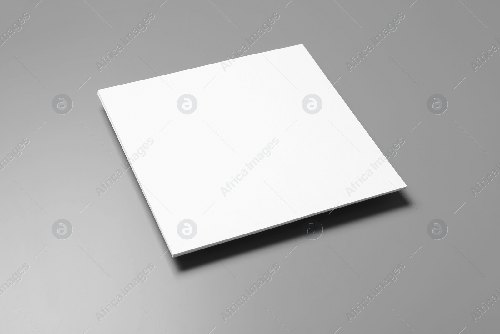 Photo of Blank paper sheets for brochure on grey background. Mock up