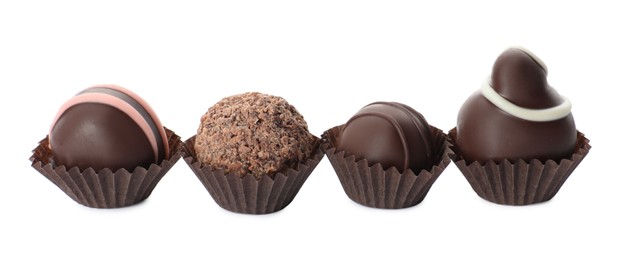 Many different delicious chocolate truffles on white background