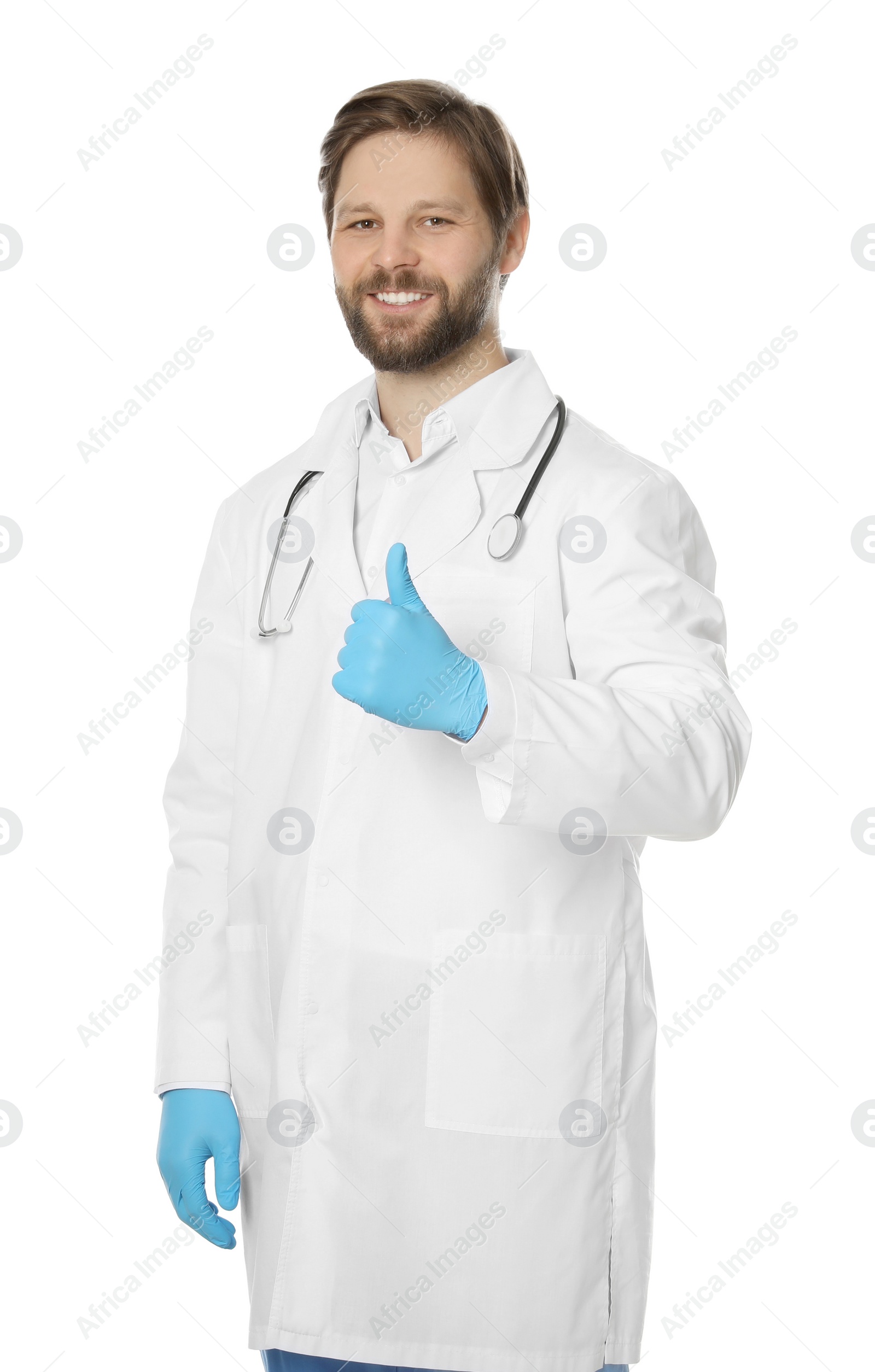 Photo of Doctor or medical assistant (male nurse) with stethoscope showing thumb up on white background