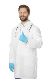 Photo of Doctor or medical assistant (male nurse) with stethoscope showing thumb up on white background