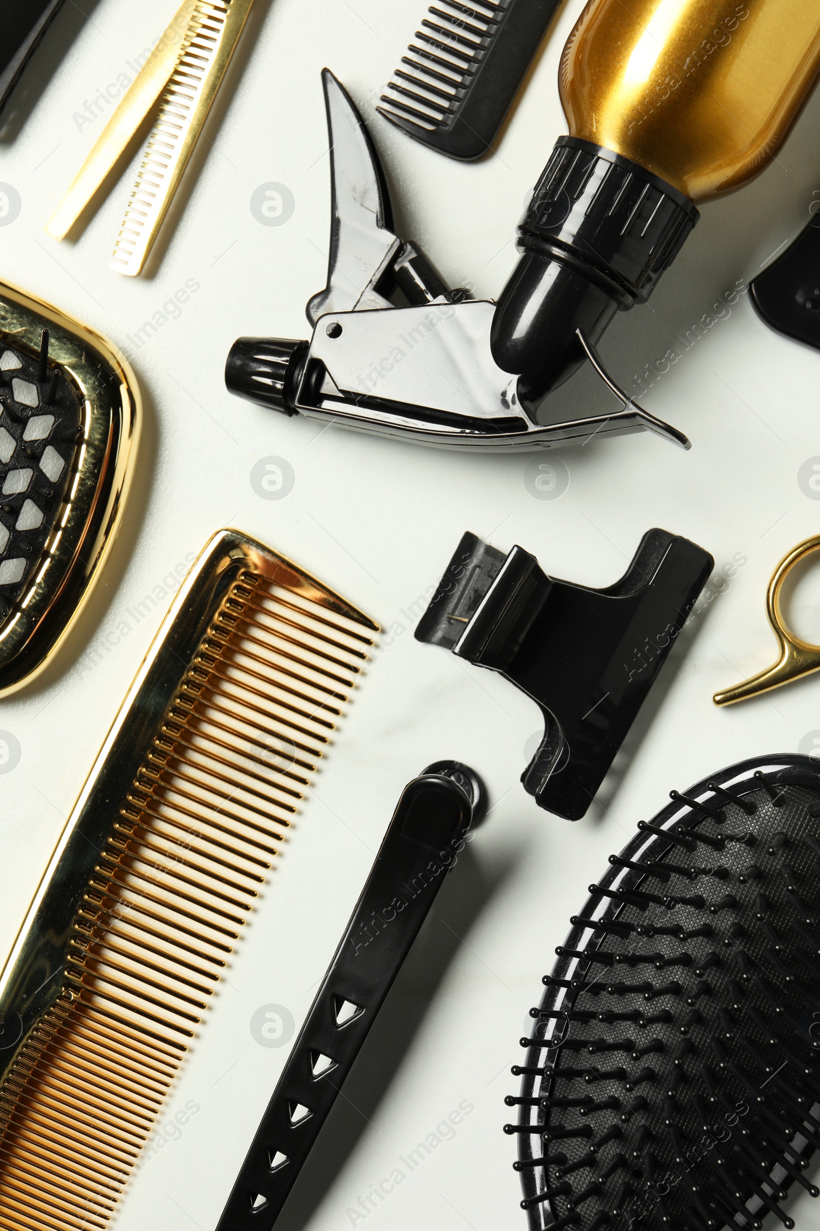 Photo of Hairdressing tools on white table, flat lay