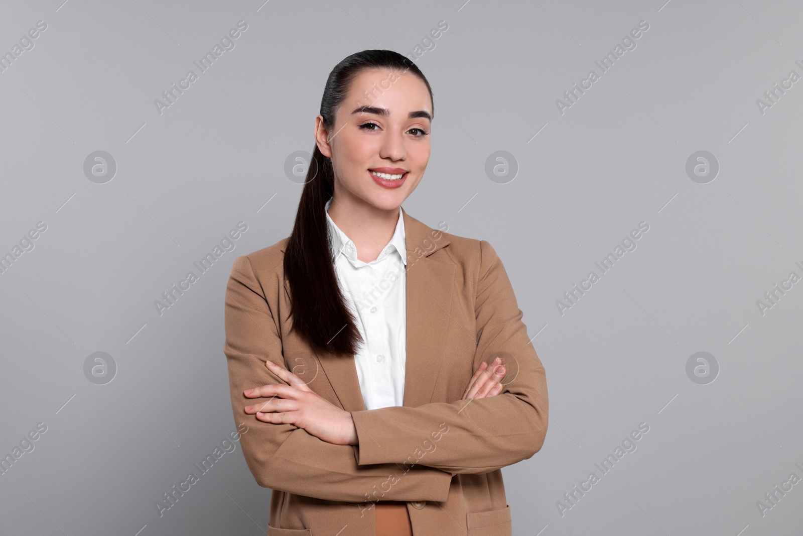 Photo of Happy real estate agent on grey background