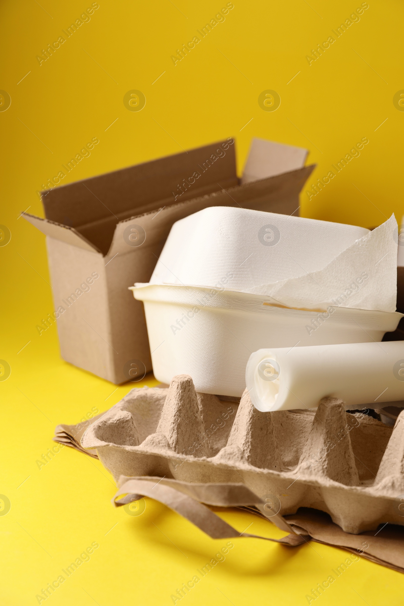 Photo of Heap of waste paper on yellow background