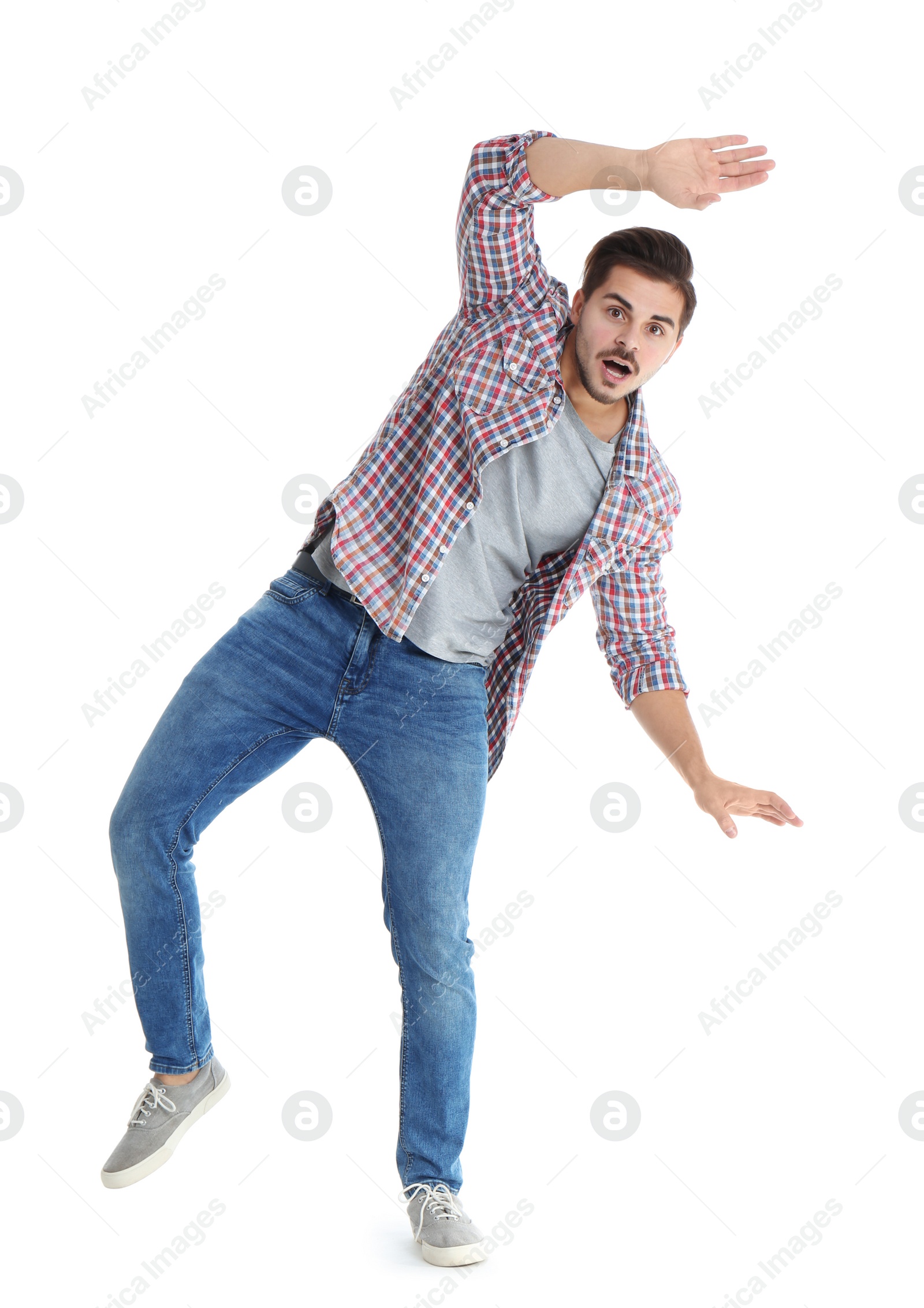 Photo of Young man attracted to magnet on white background