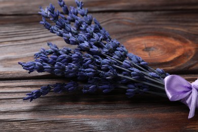 Bouquet of beautiful preserved lavender flowers on wooden table, closeup