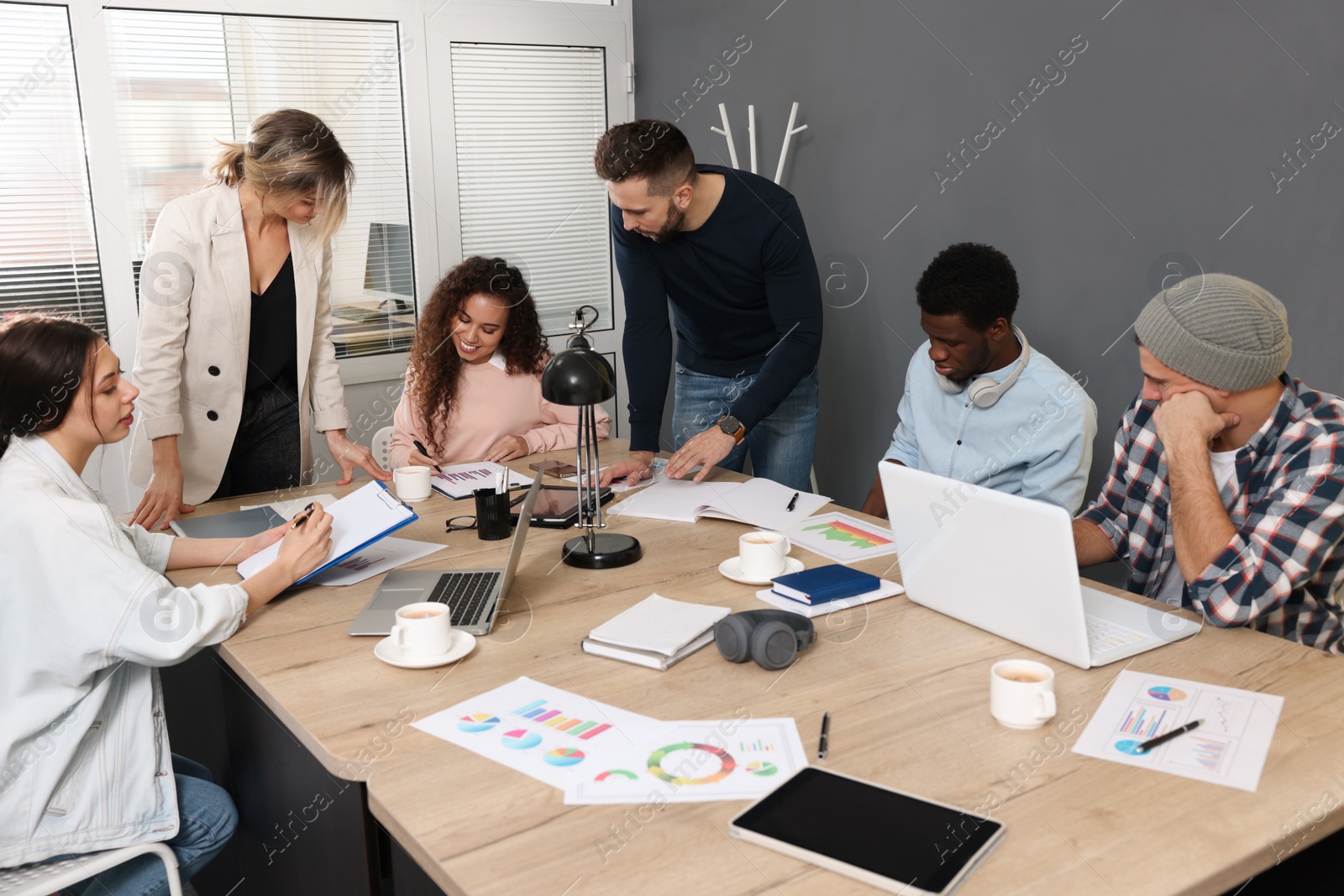 Photo of Team of employees working together in office. Startup project