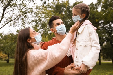 Photo of Lovely family spending time together in park during coronavirus pandemic