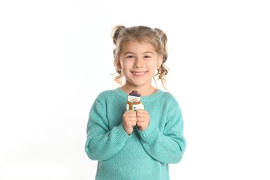 Cute little girl with Christmas gingerbread cookie on white background