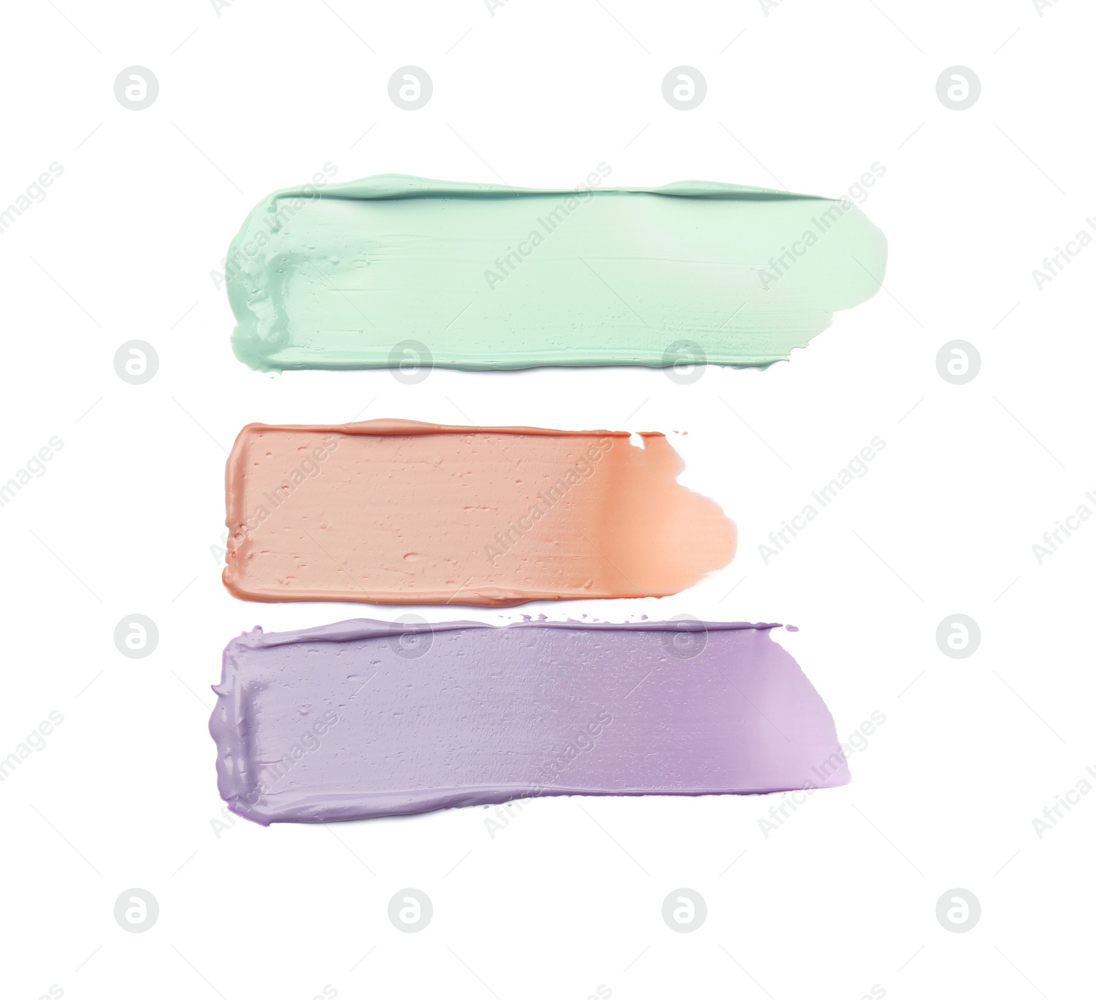 Photo of Strokes of pink, green and purple color correcting concealers on white background, top view