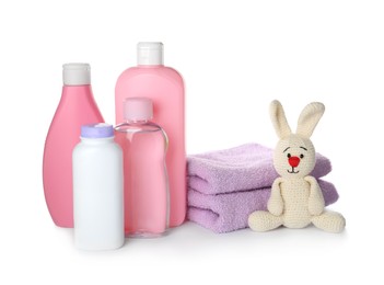 Set of baby cosmetic products, toy bunny and towels on white background