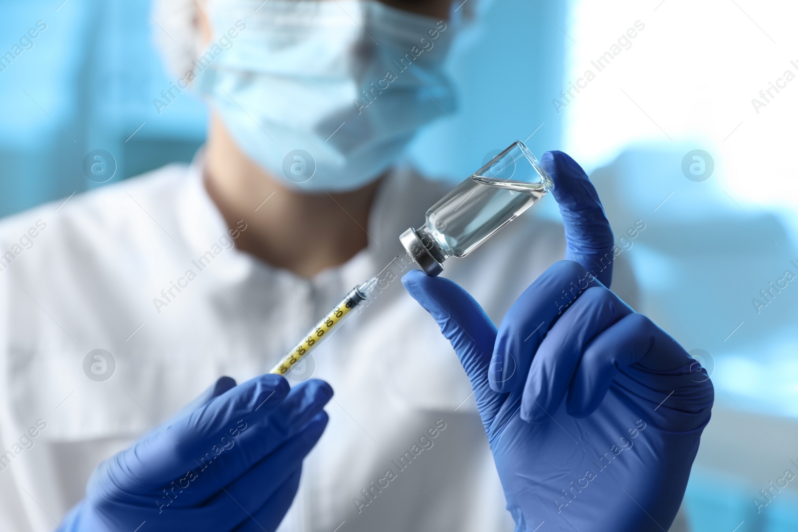 Photo of Doctor filling syringe with medication in clinic, closeup. Vaccination and immunization