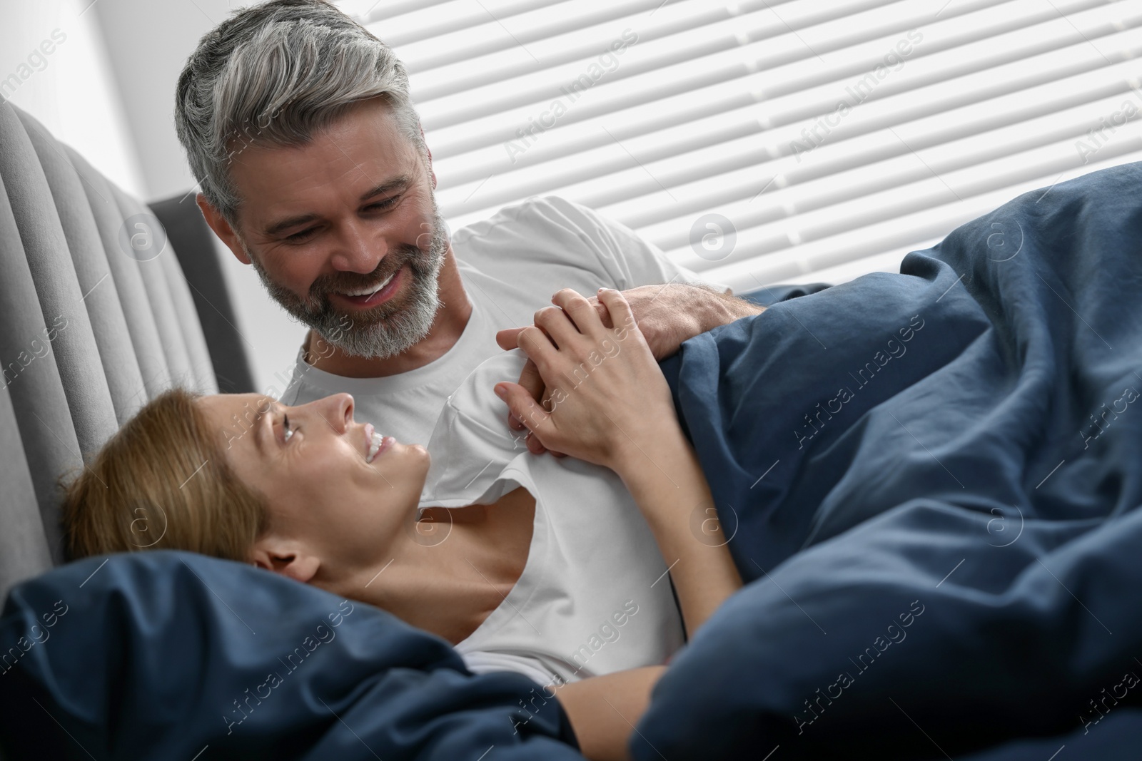 Photo of Lovely mature couple in bed at home