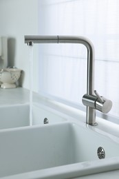Stream of water flowing from tap in kitchen