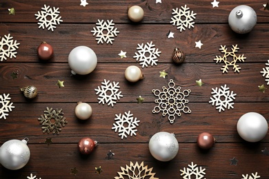 Photo of Flat lay composition with Christmas decorations on wooden background. Winter season