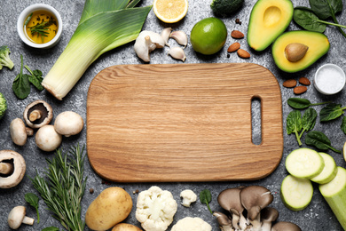 Flat lay composition with fresh products on grey table, space for text. Healthy cooking