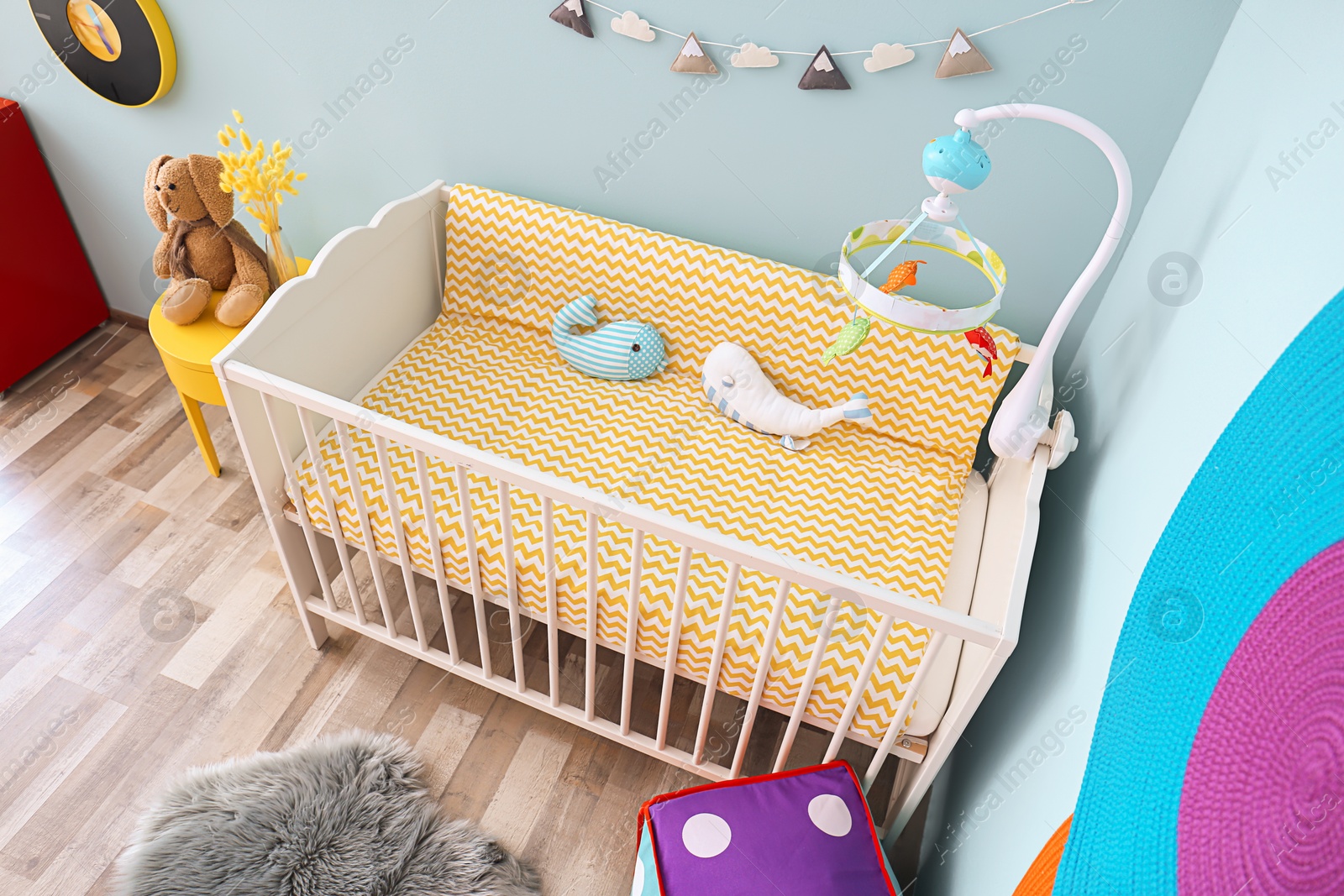 Photo of Interior of baby room with comfortable crib