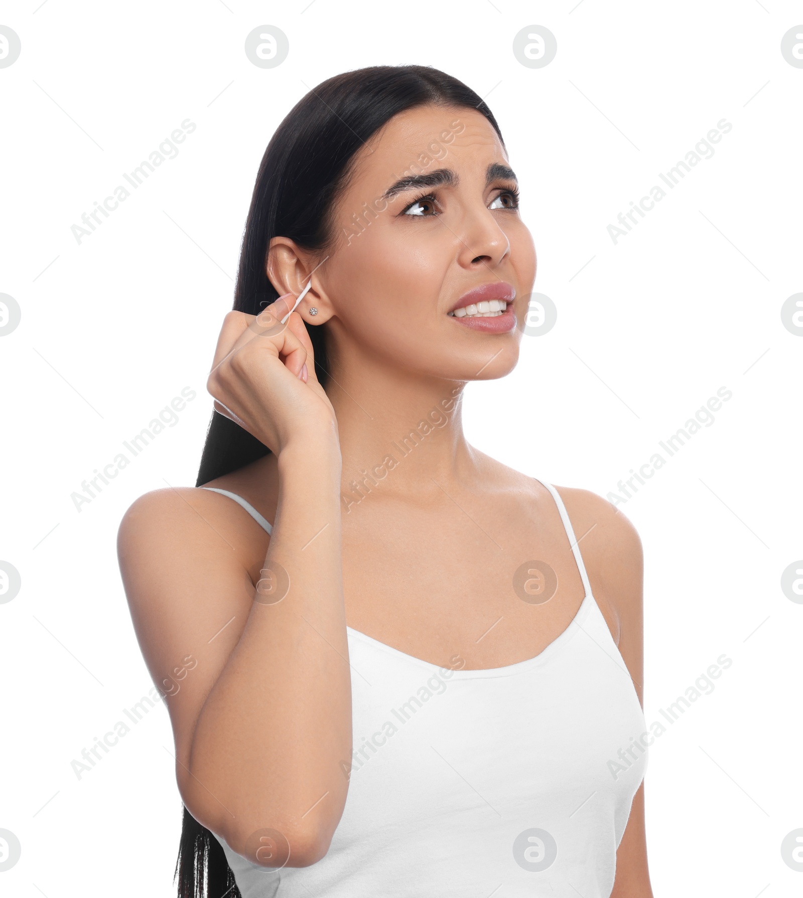 Photo of Young woman cleaning ear with cotton swab on white background