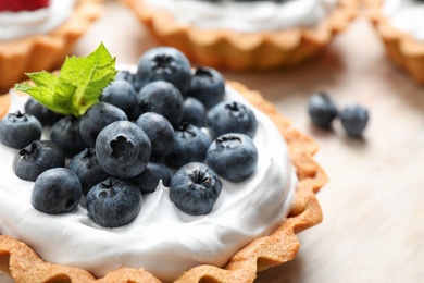 Photo of Blueberry tart on table, closeup. Delicious pastries